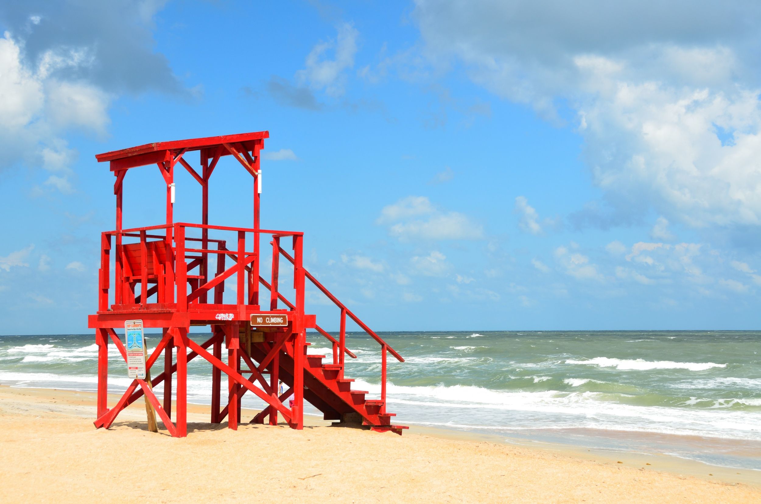Red lifeguard tower on the beach.